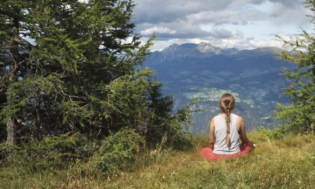 Sukasana Yoga Stilling med udsigt til bjerge i Italien